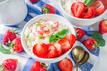 Summer morning rice pudding or rice porridge with strawberry and berry syrup in small bowl for, With milk and fresh strawberry copy space