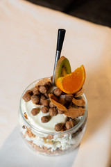 Fresh oatmeal and rice porridge with a beautiful serving and fruit. Bananas, berries, oranges and kiwi. Healthy and nutritious breakfast for children and adults. Different cereals