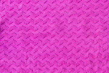 Bright pink fabric texture with zigzag pattern. Rough textile background