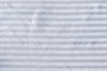 Natural gray striped linen fabric texture. Rough crumpled burlap textile background