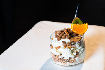 Fresh oatmeal and rice porridge with a beautiful serving and fruit. Bananas, berries, oranges and kiwi. Healthy and nutritious breakfast for children and adults. Different cereals