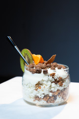 Fresh oatmeal and rice porridge with a beautiful serving and fruit. Bananas, berries, oranges and kiwi. Healthy and nutritious breakfast for children and adults. Different cereals