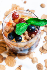 Fresh oatmeal and rice porridge with a beautiful serving and fruit. Bananas, berries, oranges and kiwi. Healthy and nutritious breakfast for children and adults. Different cereals