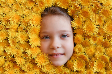 face of a girl in yellow dandelions