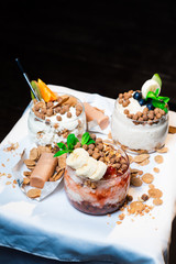 Fresh oatmeal and rice porridge with a beautiful serving and fruit. Bananas, berries, oranges and kiwi. Healthy and nutritious breakfast for children and adults. Different cereals