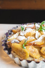 Juicy banana pie. Delicious Thanksgiving apple pie with mint or basil. Baking in the oven. Pie with banana. Sweet cupcake with baked fruit sprinkled with powder.