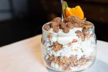 Fresh oatmeal and rice porridge with a beautiful serving and fruit. Bananas, berries, oranges and kiwi. Healthy and nutritious breakfast for children and adults. Different cereals