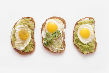 Sandwiches with vegetables, eggs, avokado and micro greens on stone background. Healthy food.
