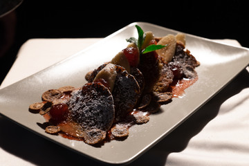 Juicy fritters with fruit for breakfast. Tasty cheesecakes with jam and bananas. Beautiful food from the restaurant cooked by a chef cook. Sweet dessert. A dish of flour and eggs.