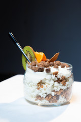 Fresh oatmeal and rice porridge with a beautiful serving and fruit. Bananas, berries, oranges and kiwi. Healthy and nutritious breakfast for children and adults. Different cereals