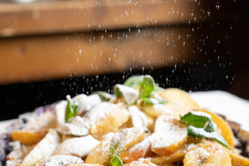 Juicy banana pie. Delicious Thanksgiving apple pie with mint or basil. Baking in the oven. Pie with banana. Sweet cupcake with baked fruit sprinkled with powder.