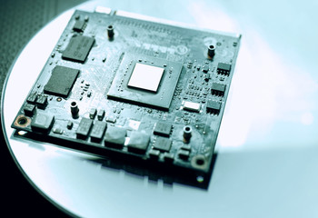 Selective focus on microprocessor on pc motherboard. Circuit Board with resistors microchips and...