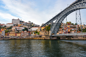 Porto, The Ribeira District, Portugal old town ribeira view with colorful houses and Luis I Bridge - a metal arch bridge over Douro River. Symbol of the city and a most popular touristic attraction