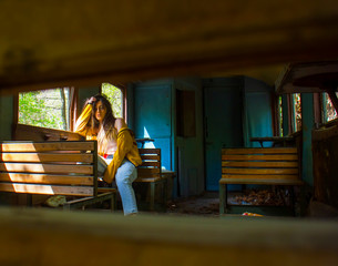 young woman sitting on a train, sexy young girl sitting on a train, young woman sitting on a chair in train