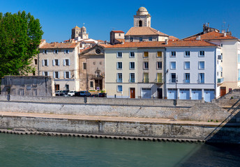 Arles. City embankment and facades of old houses.