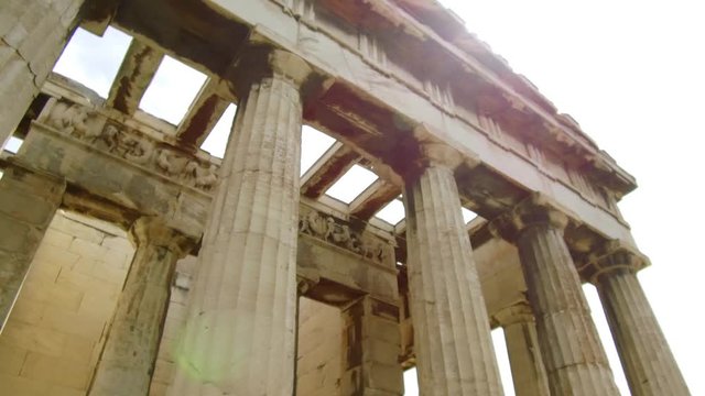 Right to left pan and tilt camera moves slowly around the Temple of Hephaestus in The roman agora of Athens