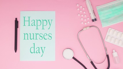 International nurses day - Medical equipment on pink background with title Happy nurses day - Stop motion 