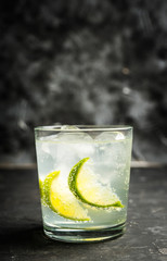 Rum based cocktail caipirinha (variation of cuba libre) on the rustic background. Selective focus. Shallow depth of field.