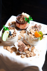 Fresh oatmeal and rice porridge with a beautiful serving and fruit. Bananas, berries, oranges and kiwi. Healthy and nutritious breakfast for children and adults. Different cereals