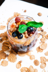 Fresh oatmeal and rice porridge with a beautiful serving and fruit. Bananas, berries, oranges and kiwi. Healthy and nutritious breakfast for children and adults. Different cereals