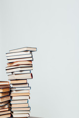 a lot of stacks of educational books for college on a white background