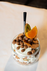 Fresh oatmeal and rice porridge with a beautiful serving and fruit. Bananas, berries, oranges and kiwi. Healthy and nutritious breakfast for children and adults. Different cereals