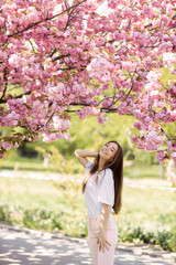 beautiful bright girl in saturated sakura