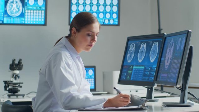 Professional medical doctor working in hospital office using computer technology. Medicine, neurosurgery and healthcare.