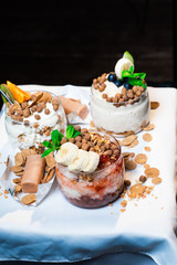 Fresh oatmeal and rice porridge with a beautiful serving and fruit. Bananas, berries, oranges and kiwi. Healthy and nutritious breakfast for children and adults. Different cereals