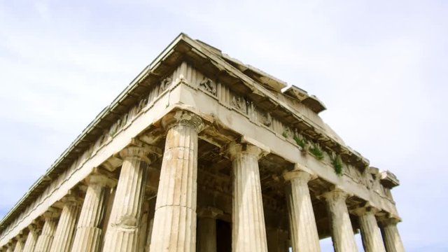 Tilt down and tracking shot camera moves slowly forward in the length of the Temple of Hephaestus in The roman agora of Athens
