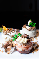 Fresh oatmeal and rice porridge with a beautiful serving and fruit. Bananas, berries, oranges and kiwi. Healthy and nutritious breakfast for children and adults. Different cereals