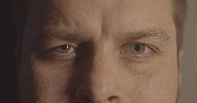 Close-up of a surprised emotional man with blue eye looking into the camera. 3840x2160, 4k