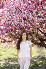 beautiful bright girl in saturated sakura