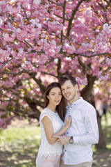 Fototapeta premium guy with a girl in sakura romance and love