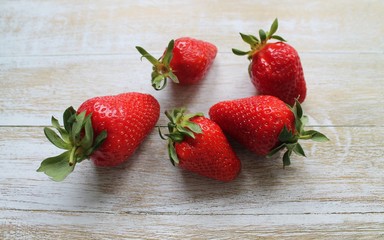Red fresh strawberries lie on a wooden Board. The concept of fresh and healthy food. The concept of delivering fresh fruit and berries home.