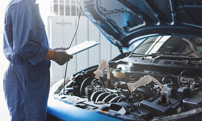 Man mechanic inspection engine with hand robot ai machine.Blue car for service maintenance insurance with car engine.for transport automobile automotive ai.