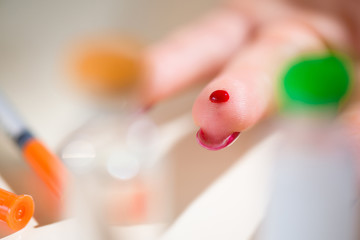 Naklejka premium Close up of asian woman hands using lancet on finger to check blood sugar level by glucose meter, Healthcare medical and check up, diabetes, glycemia concept