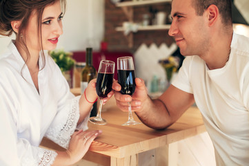 lovers in the kitchen drink wine