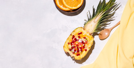 Summer concept. Pineapple tropical fruit with fresh fruits inside on concrete background. Copy space