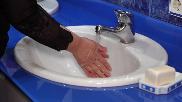 hand washing with soap to remove covid-19, virus and bacteria prevention concept.Concept of hygiene. Wash your hands with soap and water at the sink in the bathroom. Slow movement.