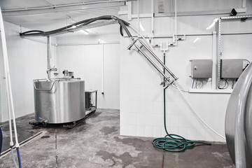 Automated cow farm, milk tanks. Milking machine, modern production technology at the factory