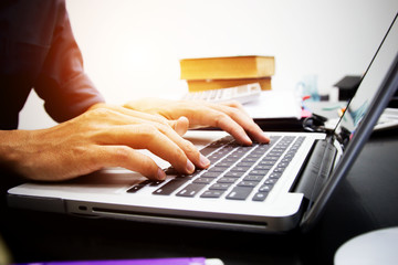 businessman working use laptop in office for discussing documents and ideas , with soft focus, vintage tone