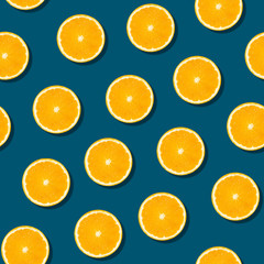 Seamless orange fruit pattern on blue background. Colorful fresh citrus slice wallpaper. Creative color, summer friuts concept. Minimal style.