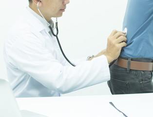 The doctor is examining the patient with back pain..