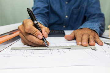 Engineer and Architect drawings blueprint  at Construction Site