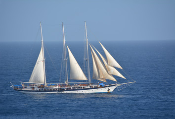 Tall-ship Mandalay sailing in the Caribbean with jibs and mizzen sails set.