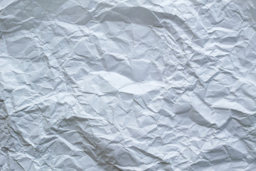 白い紙を丸めて広げた時にできた皺のテクスチャ