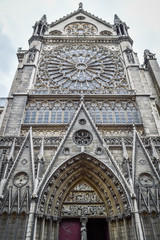 Fototapeta na wymiar Notre Dame Cathedral side view of doorway and arches in Paris France