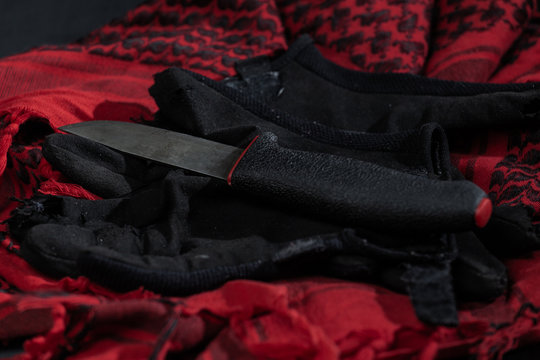 Finnish puukko knife, black combat gloves and red shemagh
