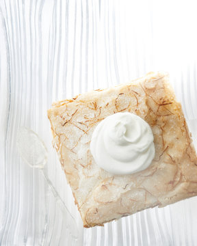 Lemon crunch cake square with whipped cream